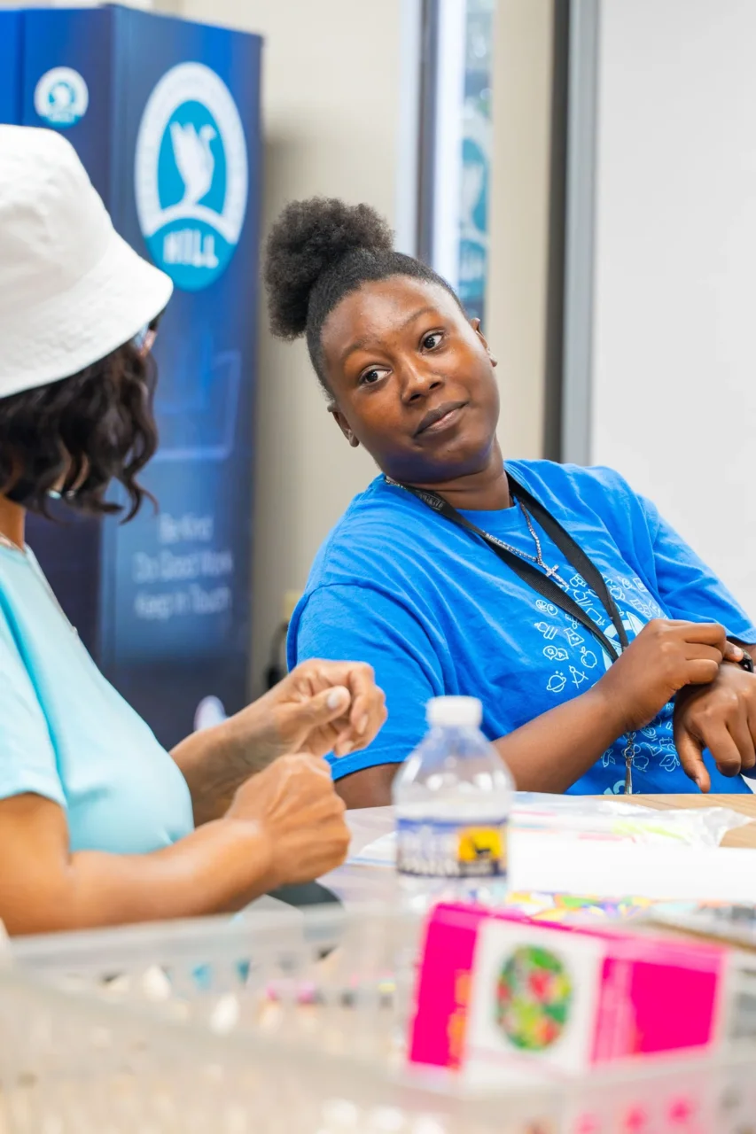 Two people in discussion at a Heron Institute learning lab, highlighting community growth across South Carolina.