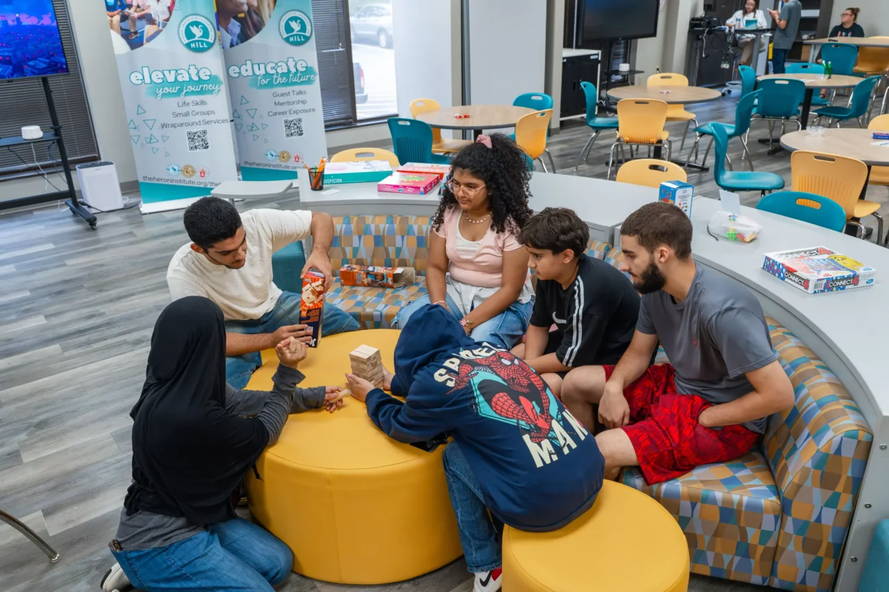 Students engage in a learning lab, playing games in a shared space designed for different ages' growth.