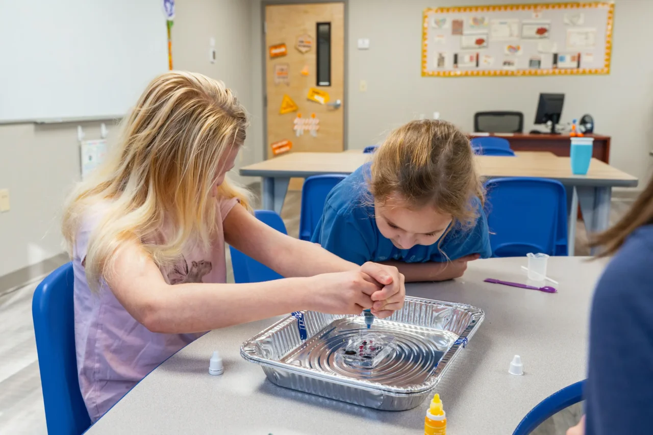 Students engaged in a science experiment at Cyber Academy, fostering school community and virtual learning.