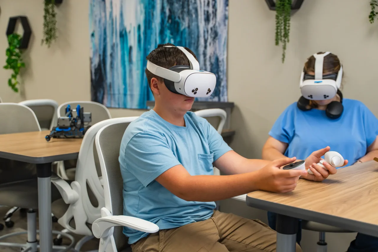 Students using virtual reality headsets in a learning lab at Cyber Academy, enhancing virtual learning experiences.
