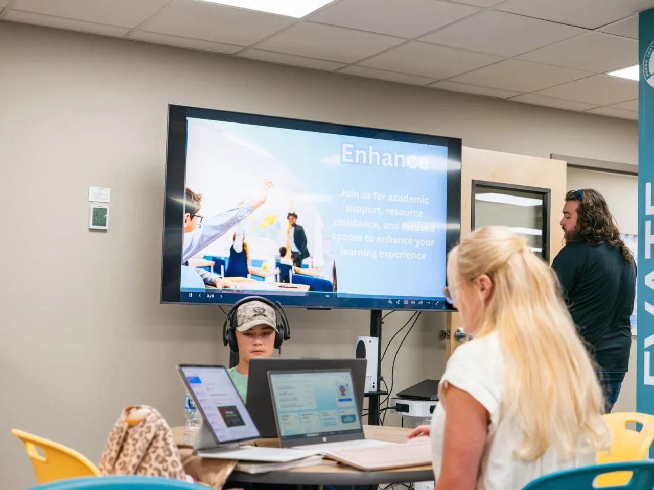 Students in a virtual learning lab receive academic support; a screen reads, "Join us for academic support.