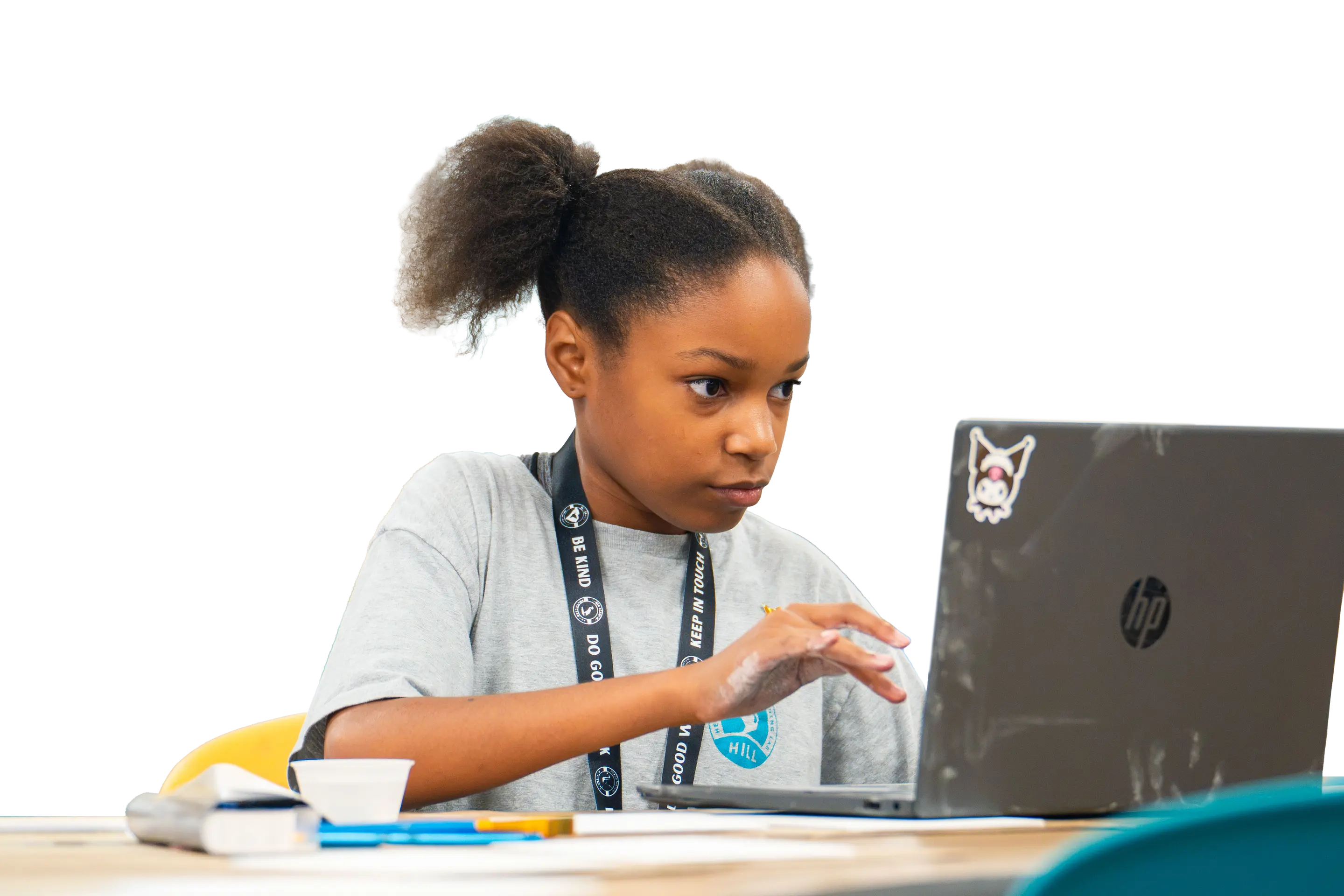 Student focused on a laptop in a virtual learning setting at Heron Virtual Academy, fostering school community.