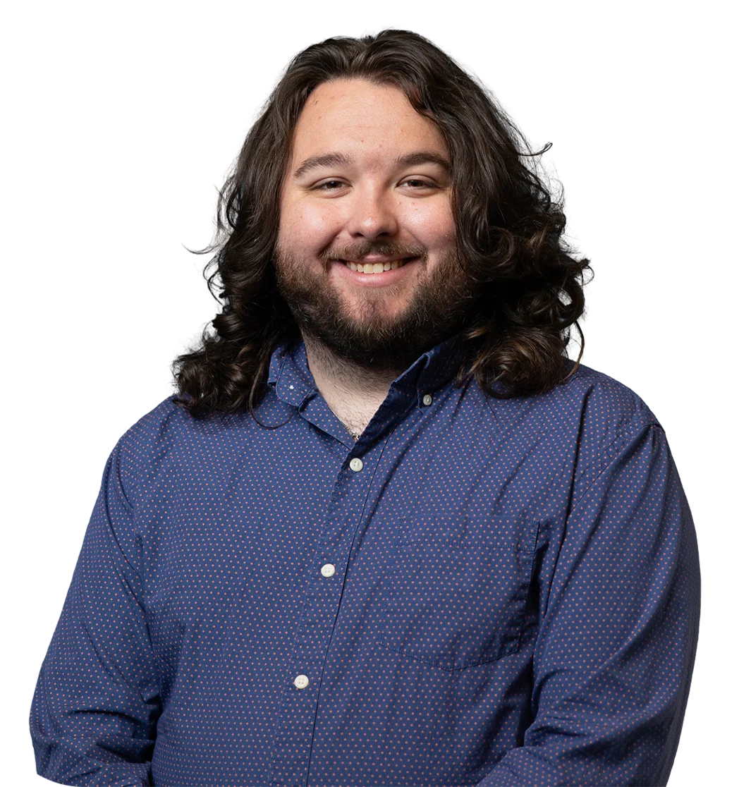 Smiling individual in a blue shirt representing the inclusive community at The HILL, supporting students enrolled in either Cyber Academy or Heron Virtual Academy.